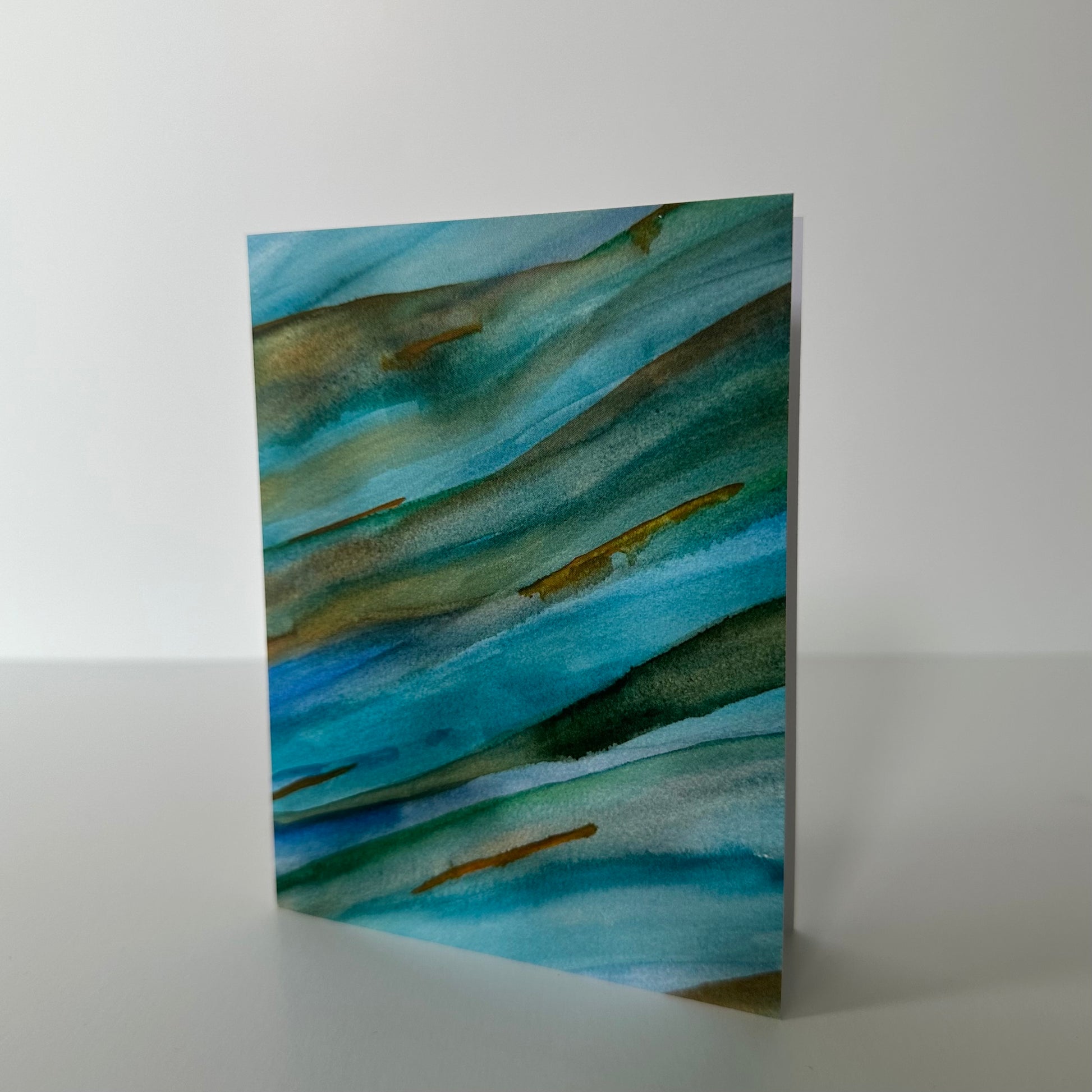 Abstract art piece with blue and green hues on a white background