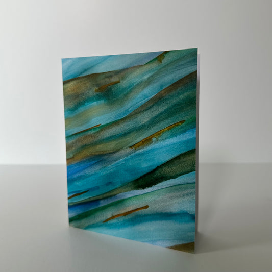 Abstract art piece with blue and green hues on a white background